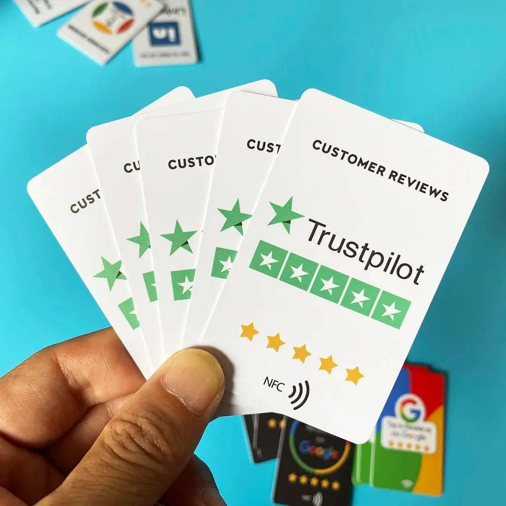 Hand hält weiße Trustpilot NFC-Karte mit grünen Sternen und Schriftzug Customer Reviews auf blauem Hintergrund.